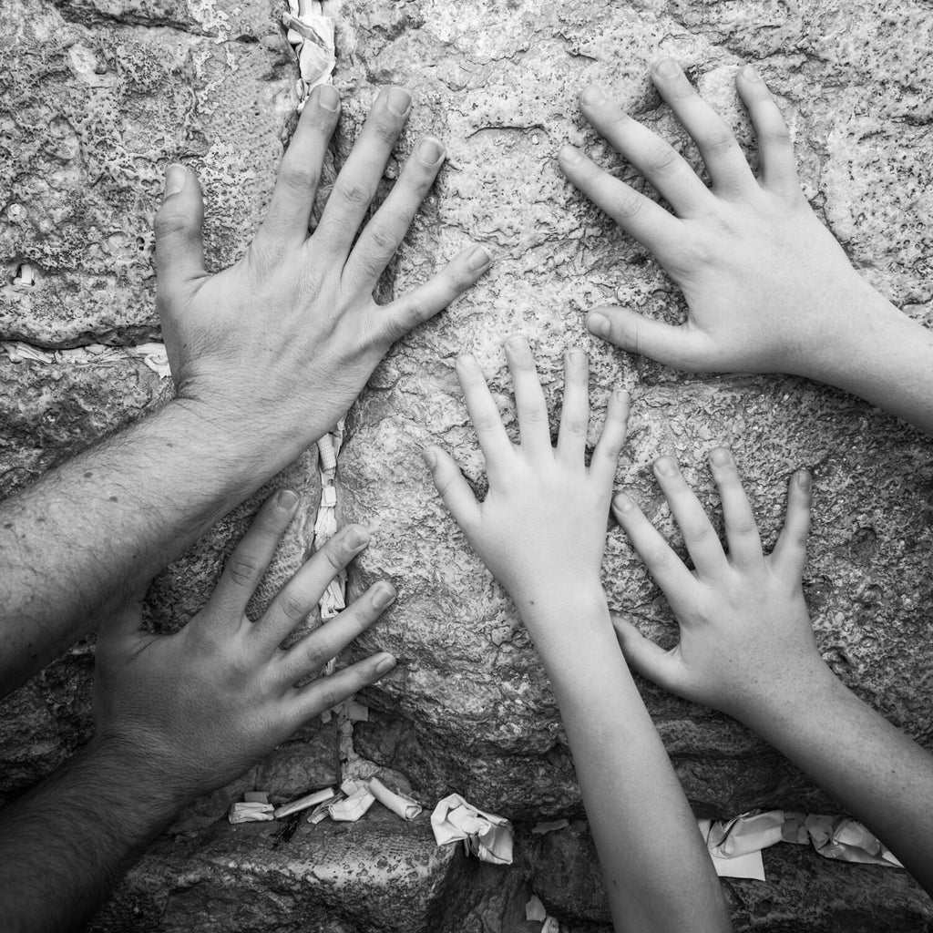 Black and White Jewish Kotel — Father & children hands praying at the Western Wall
