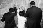 Jewish Wall Kotel — Father and sons praying on a stone of the wailing wall, the Kotel, Jerusalem