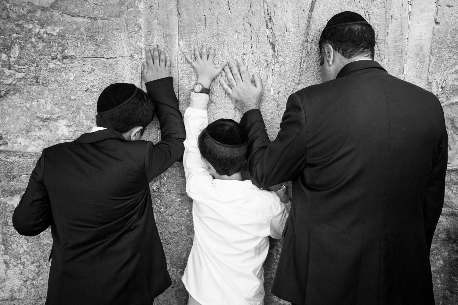 Jewish Wall Kotel — Father and sons praying on a stone of the wailing wall, the Kotel, Jerusalem