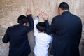 Jewish Wall Kotel — Father and sons praying on a stone of the wailing wall, the Kotel, Jerusalem
