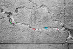 Black and White Jewish Kotel Stone with Colored Prayer Paper Notes between Stones