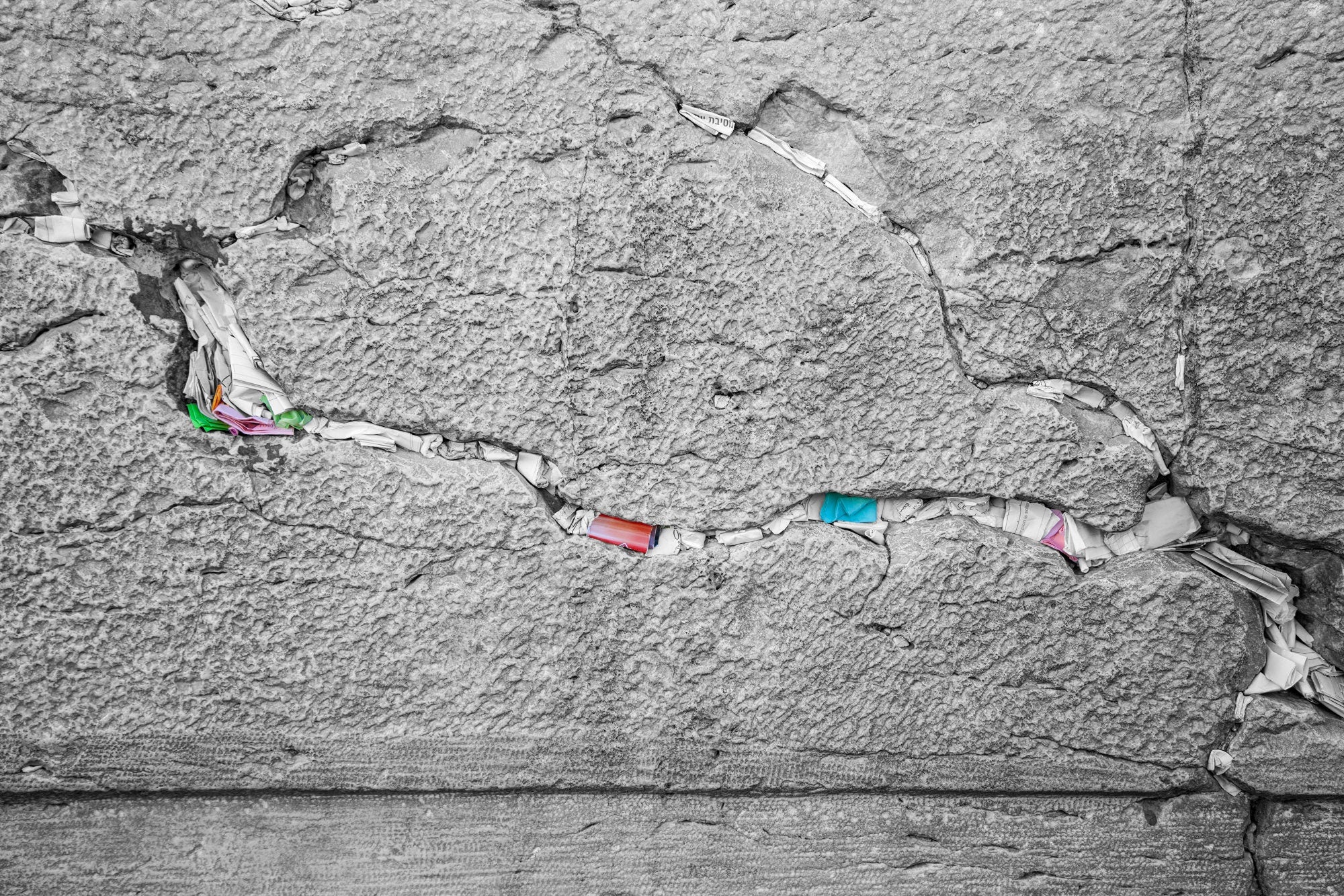 Black and White Jewish Kotel Stone with Colored Prayer Paper Notes between Stones