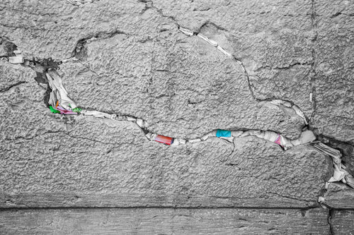 Black and White Jewish Kotel Stone with Colored Prayer Paper Notes between Stones
