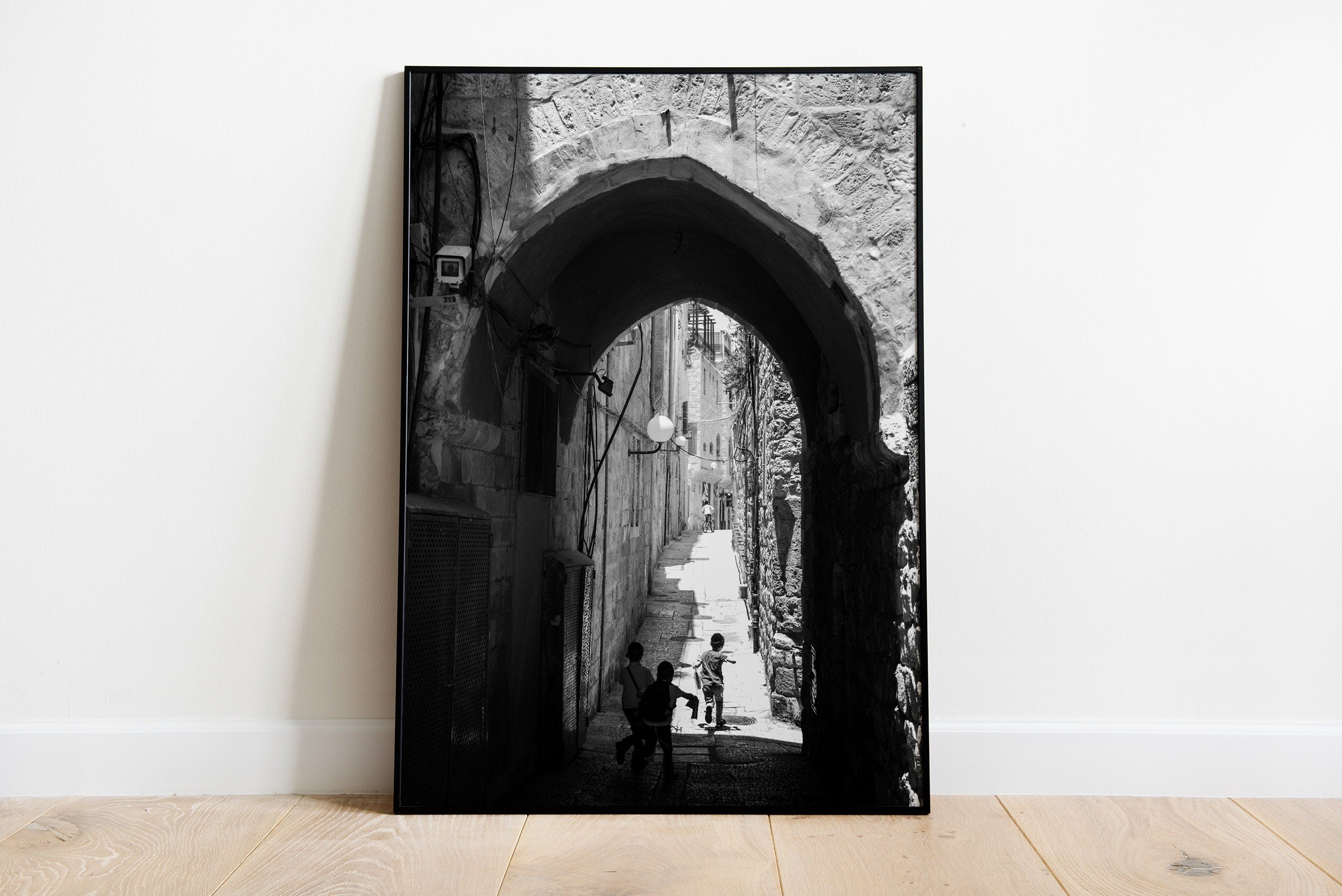 Black and White Jerusalem Old City Pedestrian Street with Jewish Children running from school and Stone Arche