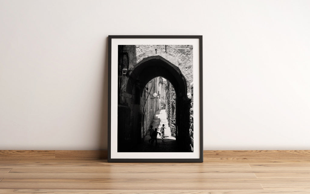 Black and White Jerusalem Old City Pedestrian Street with Jewish Children running from school and Stone Arche