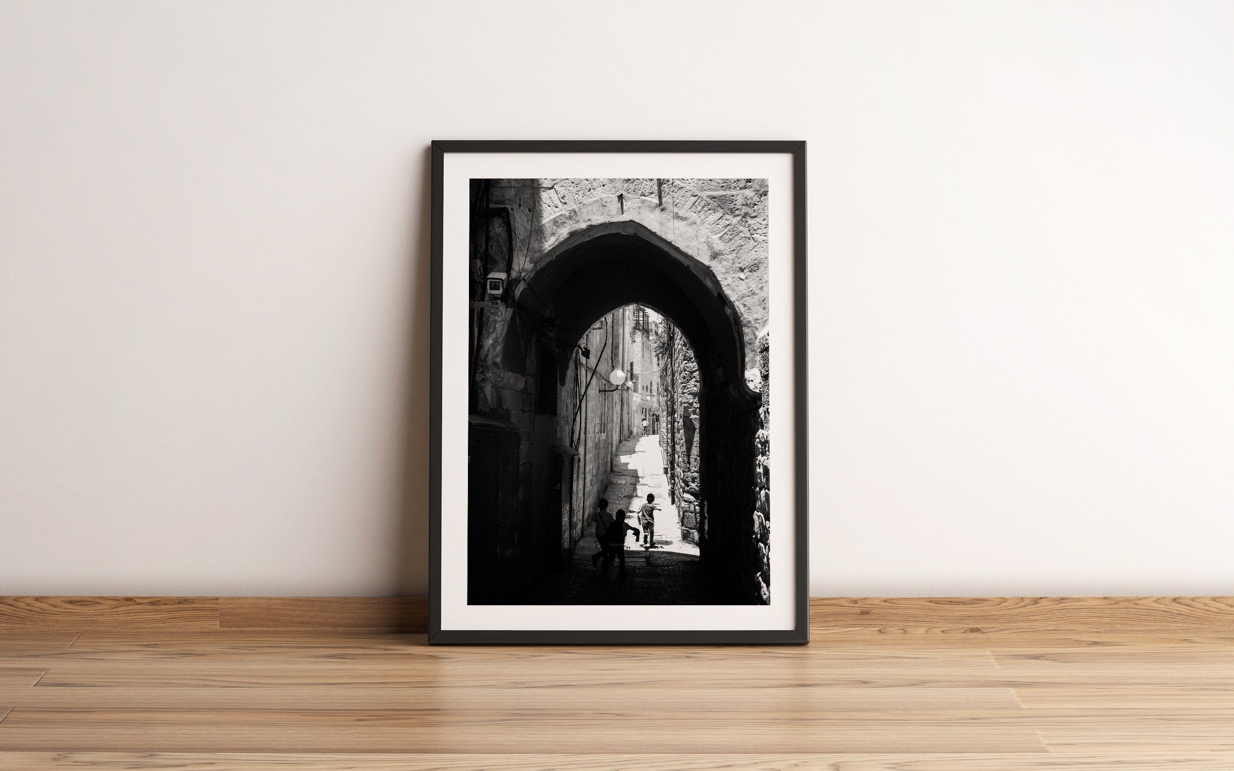 Black and White Jerusalem Old City Pedestrian Street with Jewish Children running from school and Stone Arche