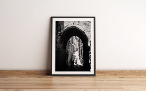 Black and White Jerusalem Old City Pedestrian Street with Jewish Children running from school and Stone Arche