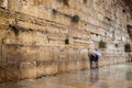 Two Prayers Alone with Umbrella at the Gold Kotel Wall Art by Night and during the Rain — Jerusalem Western Wall
