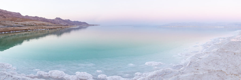 Panoramic Turquoise Dead Sea Israeli Sunset with White Salt Sea Minerals and Mountains