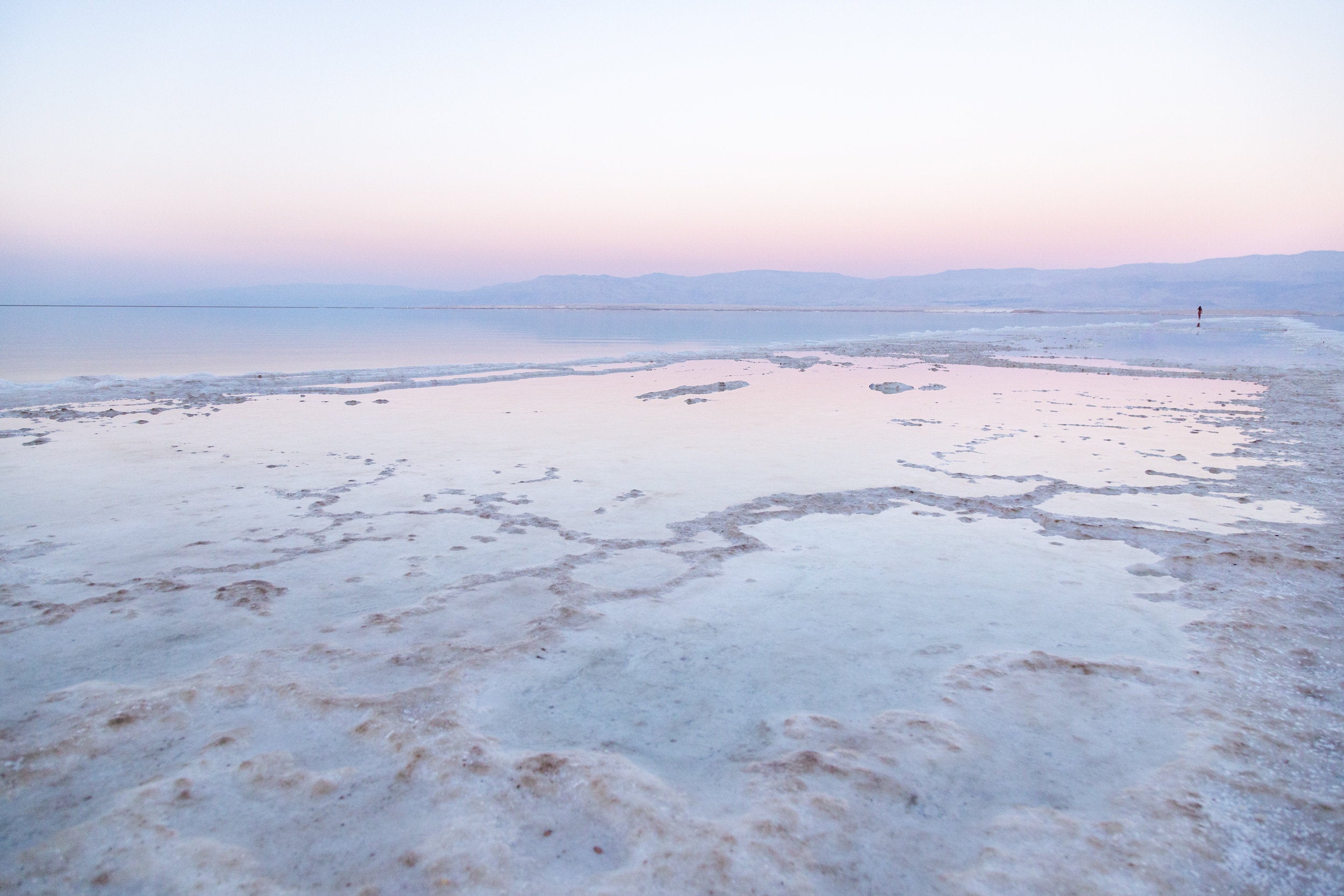 Colorful Dead Sea Israeli Holy Land Sunset with White Salt Sea Minerals and Silhouette