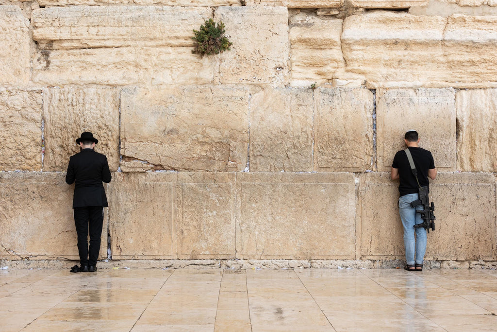 IDF Tsahal Soldier and Jewish Orthodox Praying Together at the Kotel Western Wall