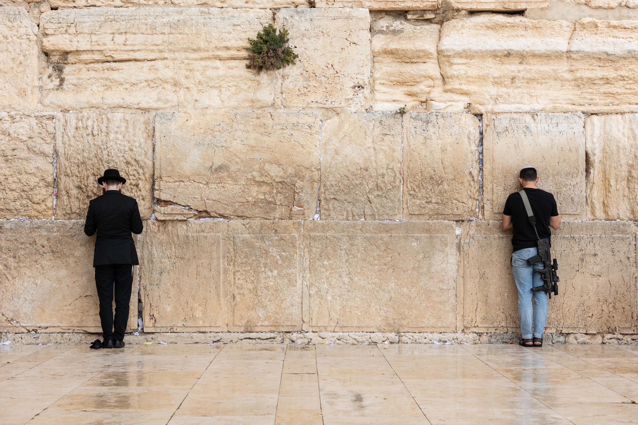 IDF Tsahal Soldier and Jewish Orthodox Praying Together at the Kotel Western Wall