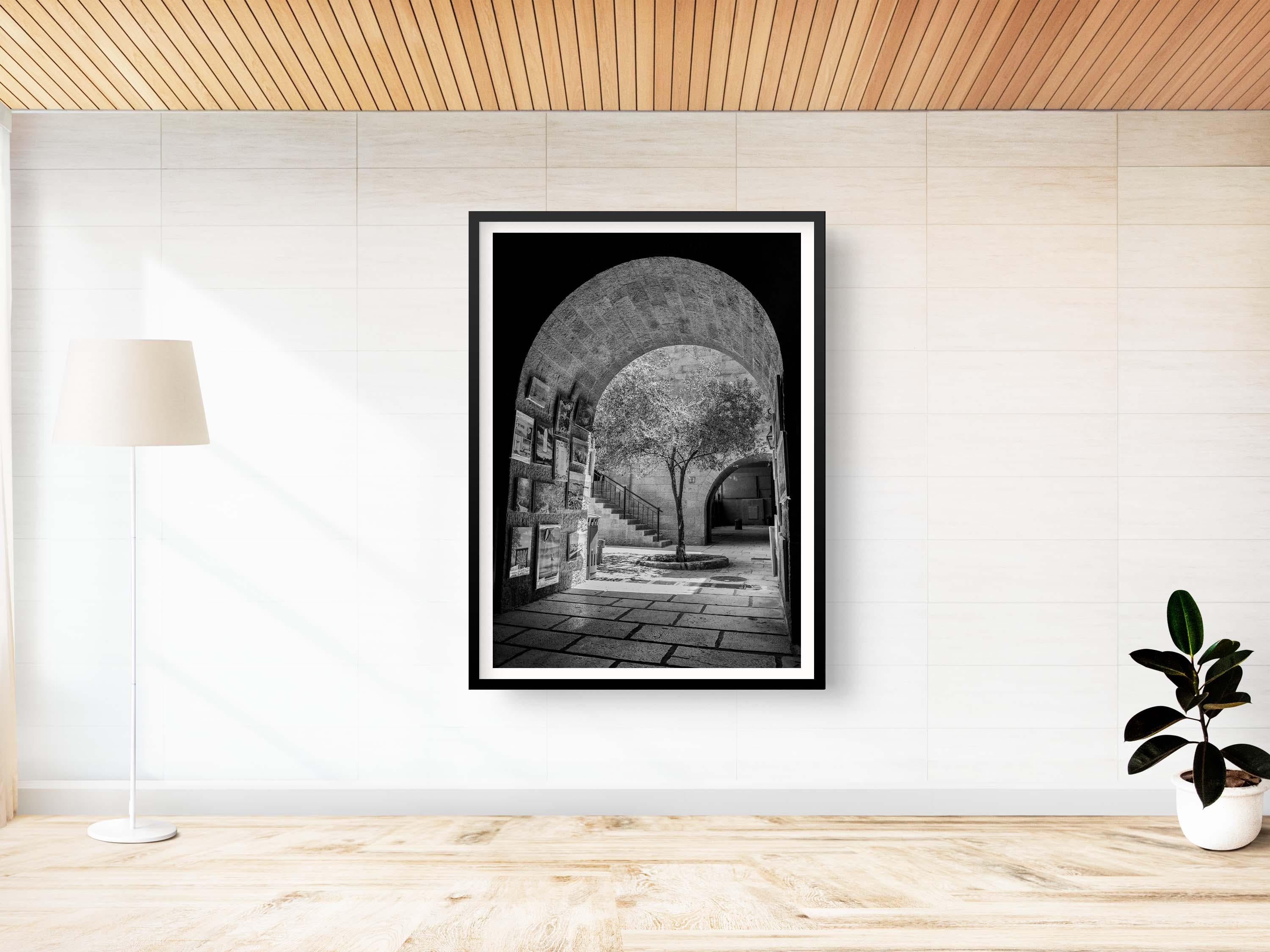 Black and White Jerusalem Old City Pedestrian Street with Olive Tree, Arch and Paintings on wall