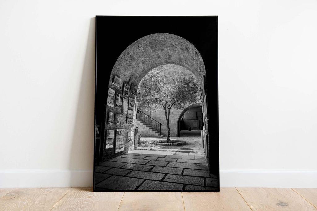 Black and White Jerusalem Old City Pedestrian Street with Olive Tree, Arch and Paintings on wall
